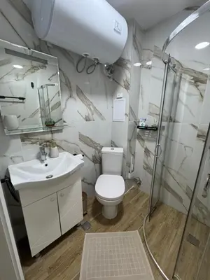 a bathroom with a toilet and a sink and a shower at Grand Villa luxury apartment with sea view in Sveti Vlas