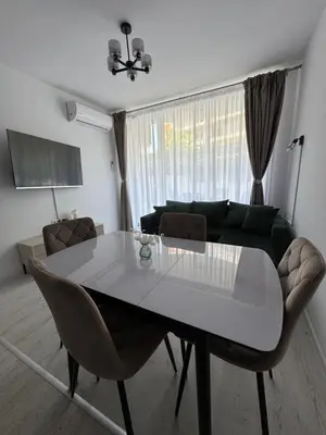 a living room with a table and a couch at Grand Villa luxury apartment with sea view in Sveti Vlas