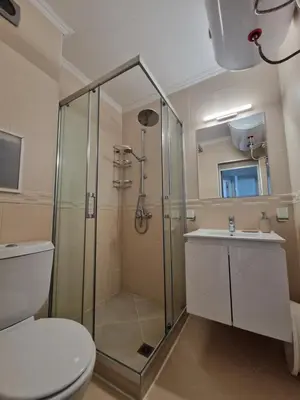 a bathroom with a shower and a toilet and a sink at Diamond beach apartment in Sveti Vlas