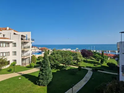 a view of a park with the ocean in the background at Diamond beach apartment in Sveti Vlas