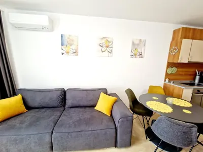 a living room with a couch and a table at Lazur 2 beach apartment in Sveti Vlas