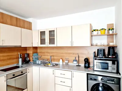 a kitchen with white cabinets and a microwave at Lazur 2 beach apartment in Sveti Vlas