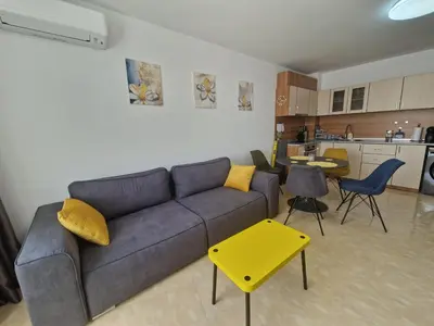 a living room with a couch and a kitchen at Lazur 2 beach apartment in Sveti Vlas
