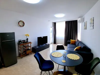 a living room with a couch and a table at Lazur 2 beach apartment in Sveti Vlas