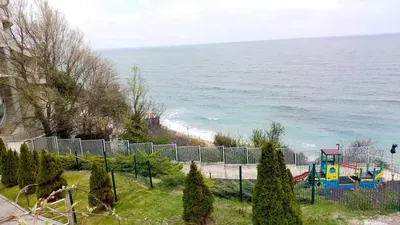 a playground next to the ocean with a fence at Studio Alma in Byala