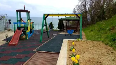 a playground with a slide and a swing set at Studio Alma in Byala