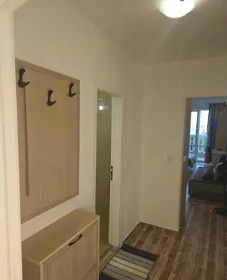 a bathroom with a sink and a door to a room at Apartman RS in Lozenets