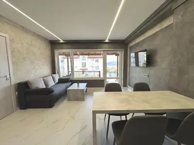 a living room with a couch and a table at Seagull Apartments in Byala