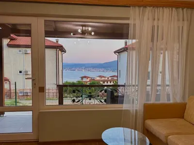 a living room with a large window with a view at Seagull Apartments in Byala