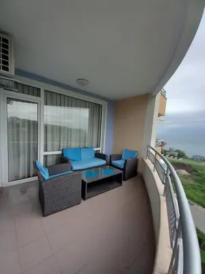 a balcony with chairs and a table on a building at Dream holiday Ravda in Ravda