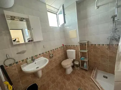 a bathroom with a sink and a toilet and a mirror at Dream holiday Ravda in Ravda