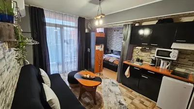 a living room with a couch and a table in a room at Studio 67 & Apartment 16 Rainbow Holiday Complex in Sunny Beach