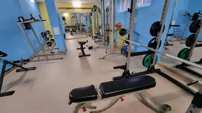 a gym with a bunch of machines in a room at Sunset Deluxe in Kosharitsa