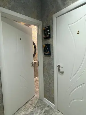 a white door in a room with a mirror at The Master and Margarita Centre in Burgas City
