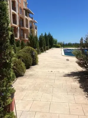 an empty sidewalk next to a building with a swimming pool at Апартамент Бяла in Byala
