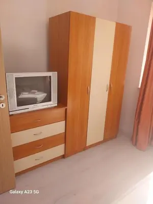 a tv on a dresser in a room at Апартамент Бяла in Byala