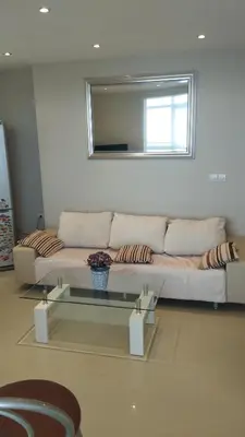 a living room with a white couch and a mirror at Yana Privilege apartment Elinite in Elenite