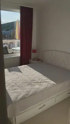 a bedroom with a large bed with a window at Yana Privilege apartment Elinite in Elenite