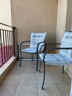 a pair of chairs sitting on a balcony at Akrotiri 2BR Apartment in Sozopol