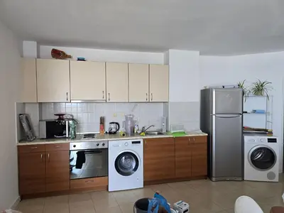 a kitchen with a refrigerator and a washer and dryer at Izabela in Pomorie
