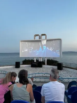 a group of people watching a movie on a screen at Izabela in Pomorie