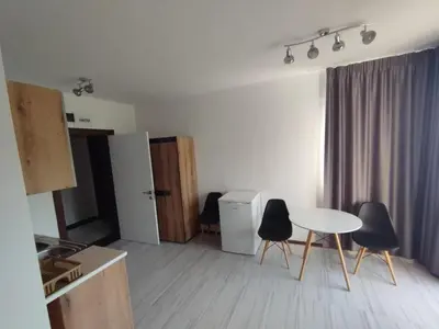 a kitchen with a table and chairs in a room at Studio Павлови Домус Екстра in Sveti Vlas