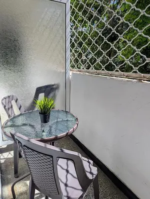 a glass table and chairs on a patio at Apartment Dimanov 1 in Burgas City