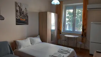 a small room with a bed and a window at Студио Слънчева перла in Burgas City
