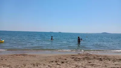 a group of people in the water at the beach at Студио Слънчева перла in Burgas City