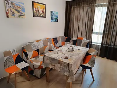a dining room with a table and chairs at Апартамент 10 улица Македония 33 in Pomorie
