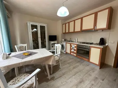 a kitchen with a table and a dining room at Shishkova Garden Apartments in Varna City