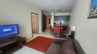 a living room with a couch and a flat screen tv at Apartment Sunset resort C4-17 in Pomorie