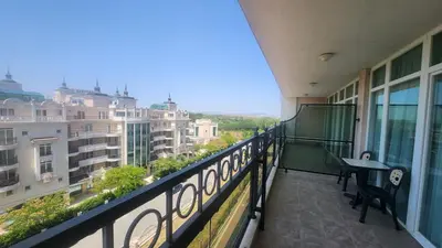 a balcony with a table and a view of a city at Apartment Sunset resort C4-17 in Pomorie
