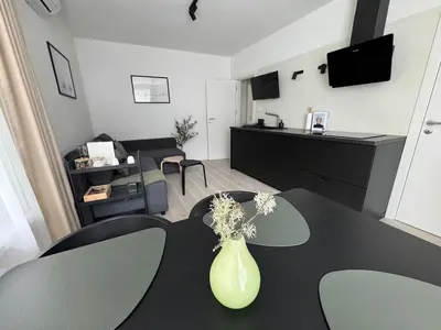 a living room with a vase on a table at Summer Apartment in Burgas City