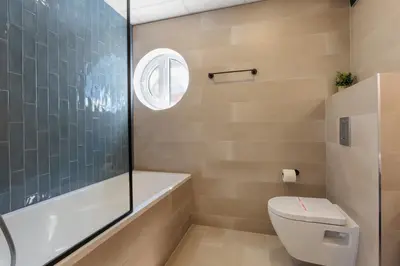 a bathroom with a toilet and a glass shower at Hotel Sea Sand in Sveti Vlas