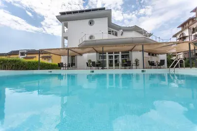 a large swimming pool in front of a building at Hotel Sea Sand in Sveti Vlas
