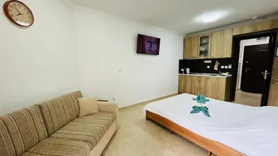 a living room with a couch and a kitchen at FREGATA STUDIO 4 Sveti Vlas in Sveti Vlas