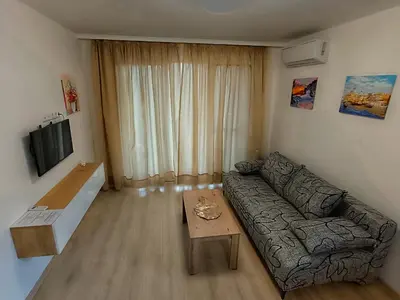 a living room with a couch and a table at Апартамент 11 улица Македония 33 Поморие in Pomorie
