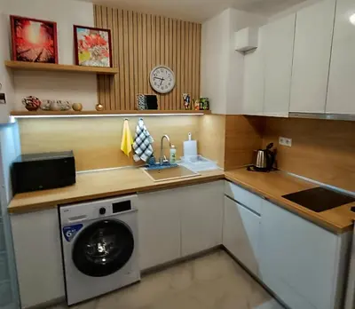 a kitchen with a washing machine and a sink at Апартамент 11 улица Македония 33 Поморие in Pomorie