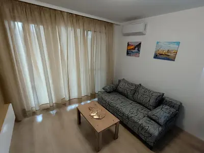 a living room with a couch and a coffee table at Апартамент 11 улица Македония 33 Поморие in Pomorie