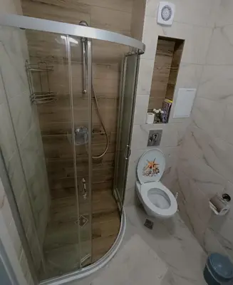 a bathroom with a shower and a toilet at Апартамент 11 улица Македония 33 Поморие in Pomorie