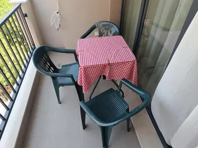 a table and two chairs on a balcony at Апартамент 11 улица Македония 33 Поморие in Pomorie