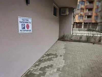a sign on the side of a building with a parking sign at Апартамент 11 улица Македония 33 Поморие in Pomorie