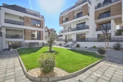 an apartment building with a lawn in front of it at BAMBOO BEACH STUDIO- Sozopol in Sozopol
