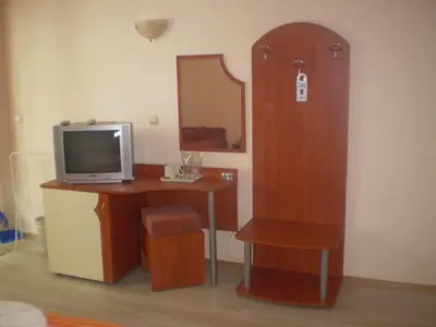 a room with a desk with a television and a mirror at Guest House ,, Ekaterina