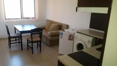 a living room with a couch and a table and a washing machine at Villa Victory Apartments in Nesebar