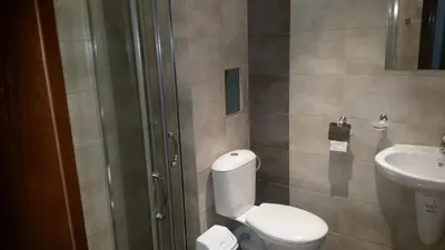 a bathroom with a toilet and a sink at Villa Victory Apartments in Nesebar