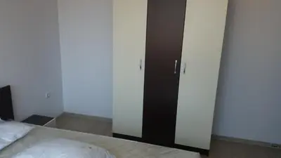 a bedroom with a bed and a black closet at Villa Victory Apartments in Nesebar