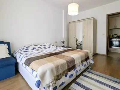 a bedroom with a bed and a blue couch at Cozy apartment on Sunny Beach in Sunny Beach