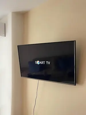 a flat screen tv hanging on a wall at Cozy apartment on Sunny Beach in Sunny Beach